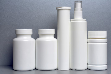 photo of five plastic cans for package pills and vitamins and antiseptic spray for protection...