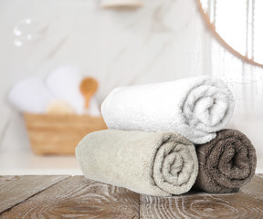 Obraz na płótnie Canvas Fresh towels on wooden table in bathroom