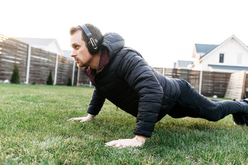 Fototapeta na wymiar A guy doing workout in the backyard