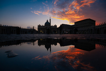 saint peter basilica in reflection during sunset