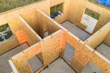 Construction of new and modern modular house. Walls made from composite wooden sip panels with...