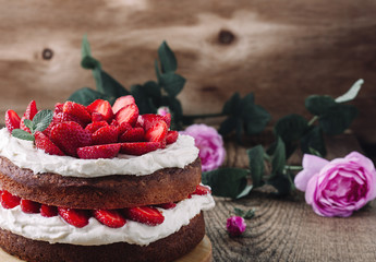 Homemade sponge cake with strawberries and cream