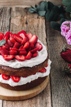 Homemade sponge cake with strawberries and cream