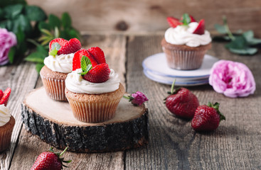 Homemade cupcakes with strawberries and cream