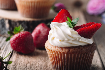 Homemade cupcakes with strawberries and cream