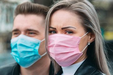 Portrait of a Couple of European appearance with medical masks.