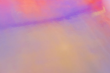 Holographic abstract soft pastel colors backdrop. Holographic foil paper close-up. Modern trendy colorful background.