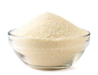 Semolina in a glass plate close-up on a white. Isolated