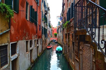 cozy quiet Venetian canal between old houses with rough walls
