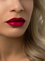 Fototapeta premium Closeup portrait of a woman with developing straight hair. Sweet tender young girl blonde. Natural lipstick, transparent clean skin. Skin care natural cosmetics in the spa salon or cosmetology.