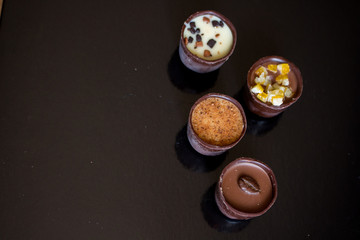 Various of sweet confectionery with chocolate candies and pralines. Handmade box of chocolates. Realistic chocolate set, delicious dessert pattern.