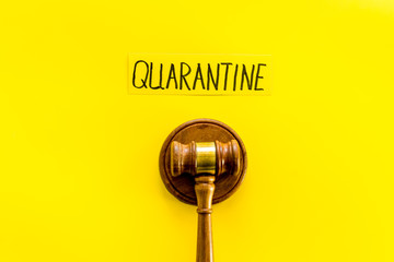 Quarantine penalty. Judge gavel on yellow background top-down