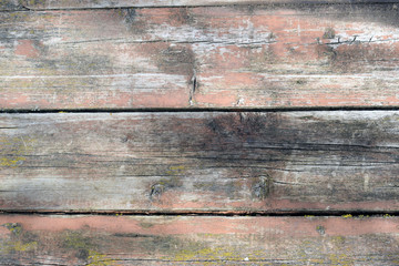 The texture of the old wooden surface with peeling paint.
