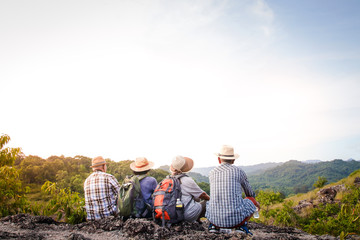 A group of Asian seniors hiking and standing on high mountains enjoying nature. Senior community...