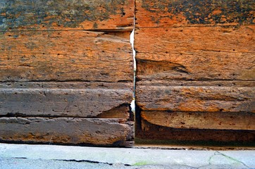 fragment of a very old wooden door with cracks and potholes