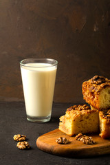 tasty  home made pie with glass of milk on wooden plate and dark background, apple pie.