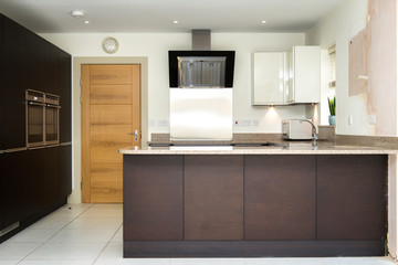modern high standard kitchen with dark furniture, in the English style