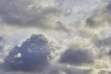 Fototapeta na wymiar low-floating Cumulus clouds at dawn against a blue sky