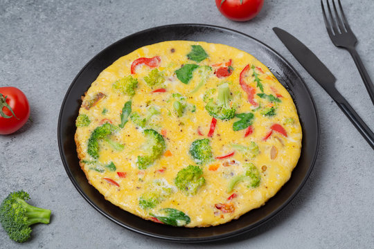 Frittata with broccoli and vegetables. Vegetarian recipe.