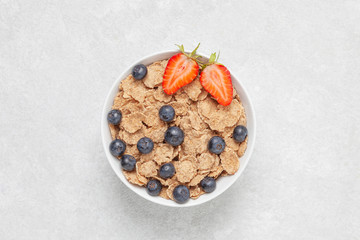 Multigrain wholewheat healthy cereals with fresh berries strawberries and blueberries. Healthy breakfast.