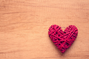 Bright red heart shape on wooden background with copy space. Valentine, love, mercy or Happy birthday concept