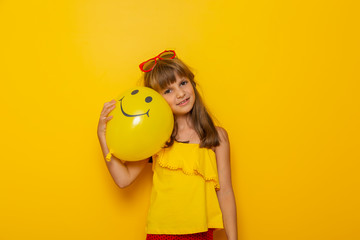 Beautiful little girl and a yellow balloon