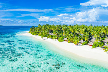 Maldives aerial island landscape. Tropical beach view from drone or plane. Exotic nature, palm trees over white sand close to coral reef, blue sea, lagoon