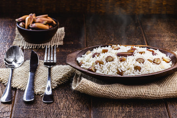 rice with pine nuts, typical Brazilian food during the winter. June food on rustic background.