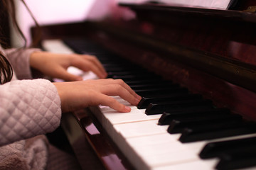 Close-up of the hand of a music performer playing a piano