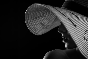 Silhouette of a girl in a white hat