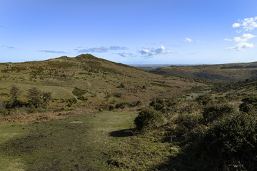 A bracketed landscape image of Sharp Tor near Dartmeet on a lovely spring afternoon, Dartmoor National Park, Devon, England. 