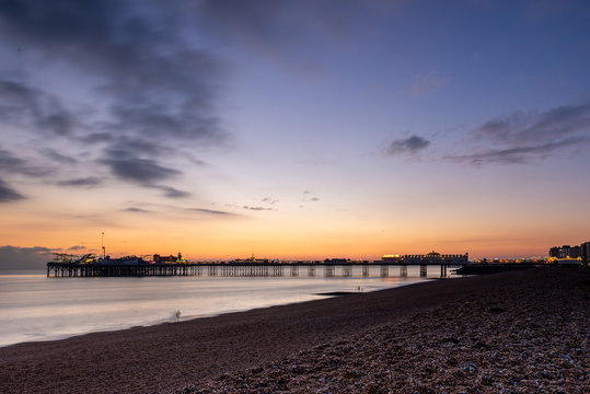 Setting sun casts an orange glow behind Brighton's silhouetted Palace Pier