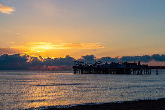 Sunset and storm clouds over the end of a pier