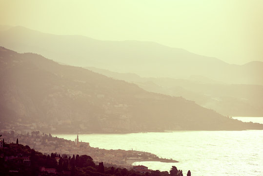 Land meets sea looking from above Monaco towards Italy