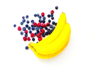 Ecological bananas and berries on white isolated background.Zero Waste concept. Close-up