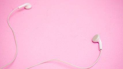 earphones on pink bckground