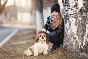 Girl and dog walk in the park