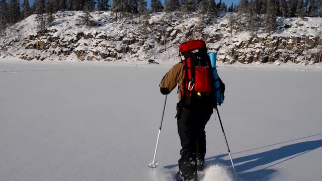 Crossing a frozen lake on snowshoes in Manitoba, Canada