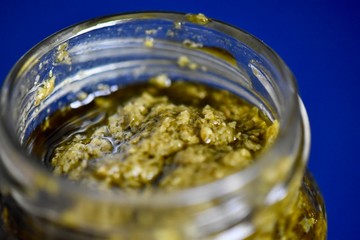Jar of fresh green basil pesto 