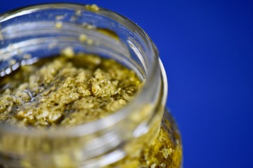 Green pesto in a glass jar 