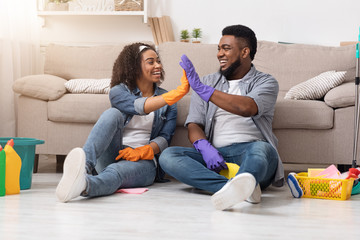 Joyful Couple Giving High Five To Each Other After Tidying Apartment