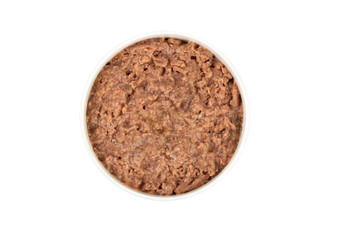 Canned pet food in round white bowl isolated on white, top view.