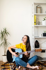 Woman spends leisure playing guitar