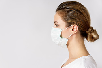 Young woman is wearing a face mask for protection against virus