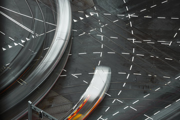 Fast blurred trail of train in traffic motion in illuminated metro, Netherlands.