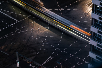 Fast blurred trail of train in traffic motion in illuminated metro, Netherlands.