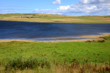 Obraz premium Orkney (Scotland), UK - August 07, 2018: The country landscape in the middle of Orkney's island, Scotland, Highlands, United Kingdom
