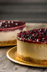 cream cake and red berries on wooden table