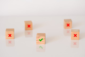 Yes or No symbols on wood blogs cube. True and false symbols on white background. Decision or choice concept.