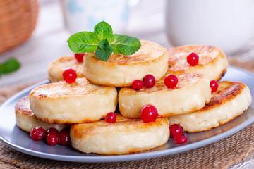 Cottage cheese pancakes with berries on a plate